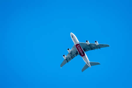 LONDON, UK - MAY 25, 2014: An Emirates plane flying in clear blue sky over London.のeditorial素材