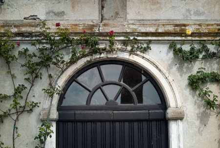 Varenna, Italy - September 4th, 2015: closeup photo of a black door at Villa Monastero in Varenna, Italy.のeditorial素材