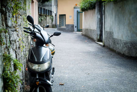 closeup photo of a motorbike parked in the street in Bellagio, Lombardy, Italy.の写真素材