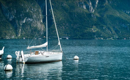 Bellagio, Italy - September 2nd, 2015: photo of a white boat floating on Lake Como near the town of Bellagio, Lombardy, Italy.のeditorial素材