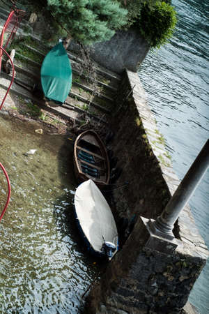 photo of three boats kept in the shallow waters of Lake Como, Italyの写真素材
