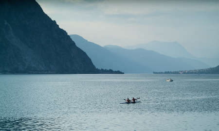Lecco, Italy - September 1st, 2015: Two canoe rowers photographjed at Lake Como near Lecco, Italy, on September 1st, 2015.のeditorial素材