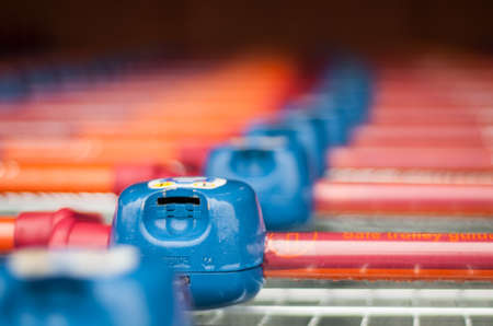 LONDON, UK - 4TH JANUARY, 2015: A row of shopping trolleys outside Sainsbury's one of UK's supermarket giants.のeditorial素材