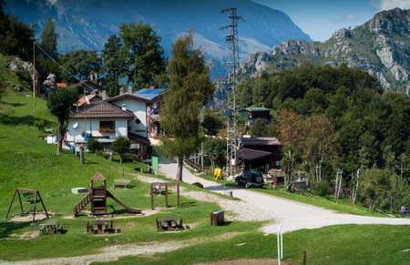 Piani d'Erna, Italy - September 7th, 2015: a group  of countryside houses and a wooden playground photographed at Piani d'Erna (part of the Alps) near Lake Como in Italyのeditorial素材