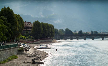 two men fishing in the River Adda on a murky morning in Lecco, Italyの写真素材