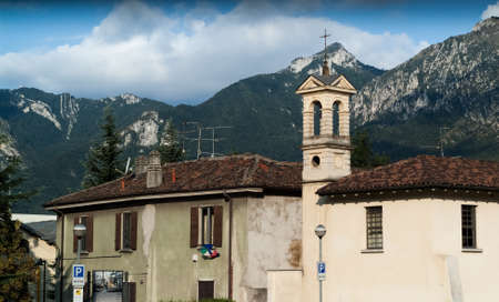 photo of a bell tower next to an old building in Lecco, Lombardy, Italyの写真素材