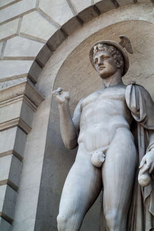 closeup photo of a nude man sculpture on a building facade in Milan, Italyのeditorial素材
