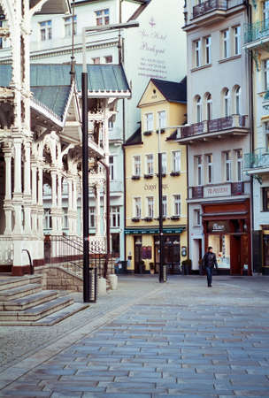 Karlovy Vary, Czech Republic - January 25, 2015: a pedestrian walking past the Market Colonnade in the Trziste Street in Karlovy Vary (Carlsbad), Czech Republic, photographed on January 25th, 2015.のeditorial素材