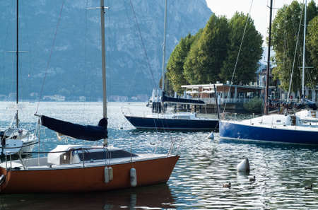 boats floating on the glittery waters of Lake Como in Italyの写真素材