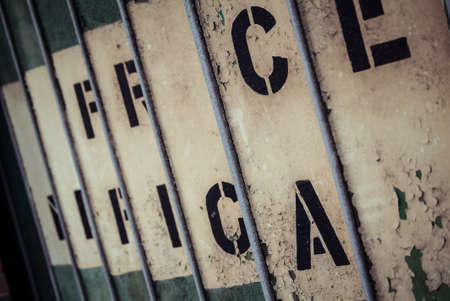 abstract photo of a metal gate with printed lettersの写真素材