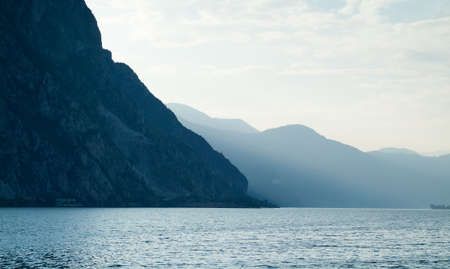 mountains near Lake Como in Italy disappearing in evening sunlightの写真素材