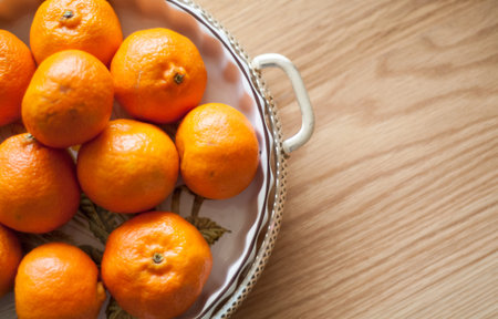 bright orange citruce fruit in a traditional dish on a wooden table