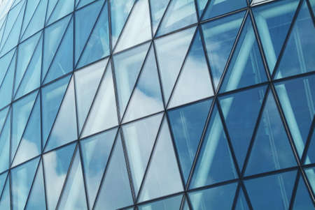 photo of the sky reflected in the glass windows of a skyscraperの写真素材
