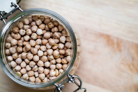closeup photo of a glass jar with chickpeasの写真素材