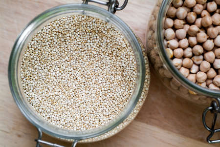 closeup photo of glass jars with chickpeas and quinoaの写真素材