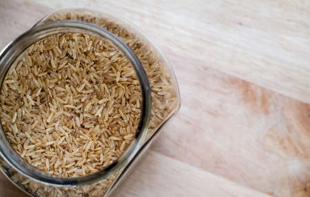 closeup photo of a glass jar with brown riceの写真素材