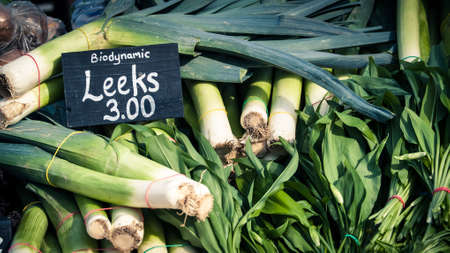 fresh leeks sold at a market stallの写真素材