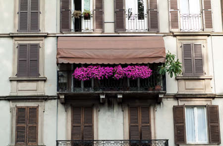 photo of a traditional Italian balcony decorated with plants and flowersの写真素材