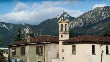 photo of a bell tower next to an old building in Lecco, Lombardy, Italyの写真素材
