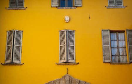 bright yellow facade photographed in Italyの写真素材