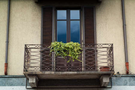 closeup of a balcony on a yellow house in Italyの写真素材
