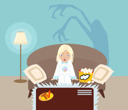 little girl watching a horror movie on TVの写真素材