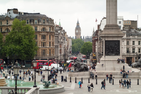 London, UK - May 23rd, 2015: tourists enjoying themselves in Trafalgar Square among the famous fountains, lions, Nelson's Column, and other must-see London attractions.のeditorial素材