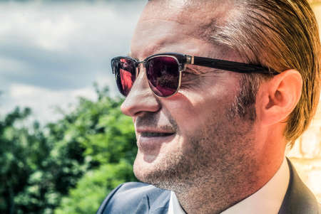 closeup portrait of a handsome man in a smart suitの写真素材