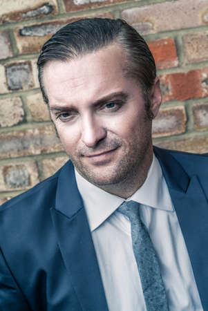 closeup portrait of a handsome man in a smart suitの写真素材