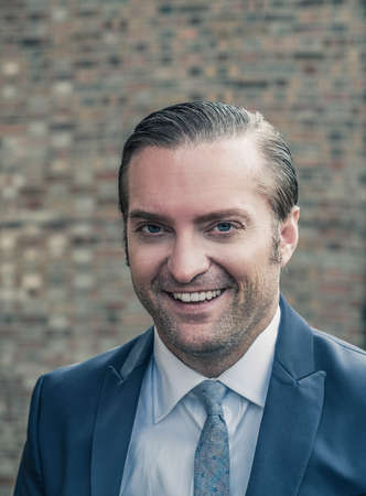 closeup portrait of a handsome man in a smart suitの写真素材