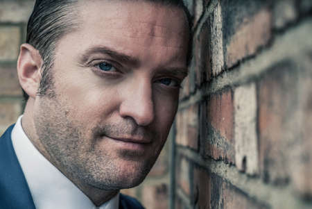 closeup portrait of a handsome man in a smart suitの写真素材