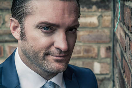 closeup portrait of a handsome man in a smart suitの写真素材