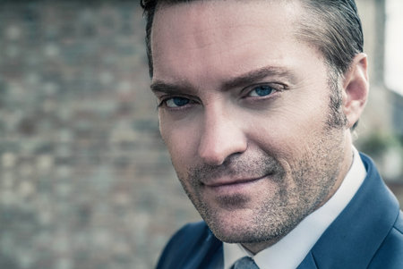 closeup portrait of a handsome man in a smart suit