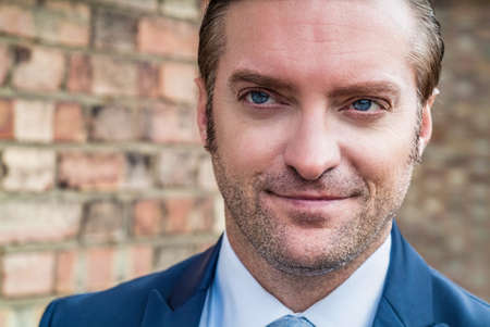 closeup portrait of a handsome man in a smart suitの写真素材