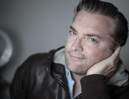 portrait of a handsome man in a leather jacketの写真素材