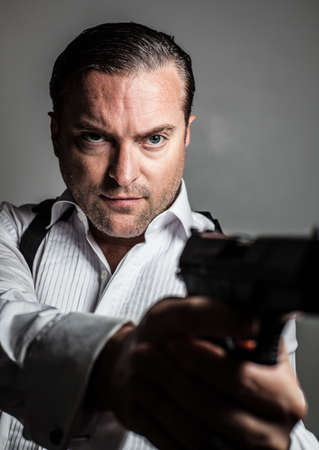 portrait of a handsome man holding a gunの写真素材