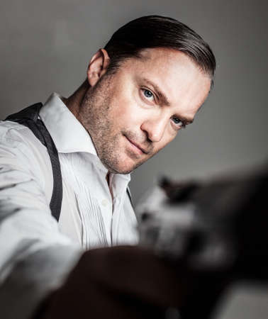 portrait of a handsome man holding a gunの写真素材