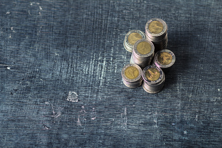 Coin Many piles on the blackboard Natural lightの写真素材