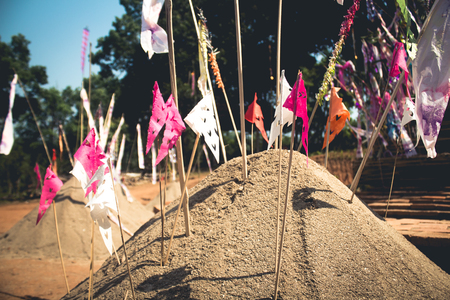 Sand pagoda Songkran festival Paper flag on the pile of sand Evening light In the countryside Chiang Maiの写真素材