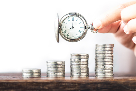 Money growth coin silver and tree young hand   White background and Old silver pocket watch clockの写真素材
