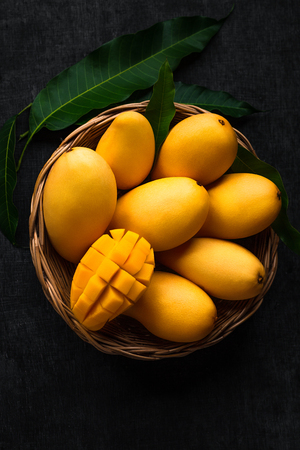 Yellow Mango Beautiful skin In the basket Blackboard backgroundの写真素材