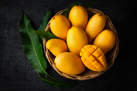 Yellow mango Beautiful skin In the basket In white backgroundの写真素材