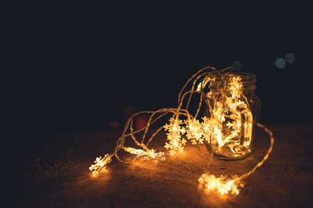 A small light shaped like an orange snowflake at night light