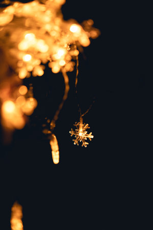 A small light shaped like an orange snowflake at night light