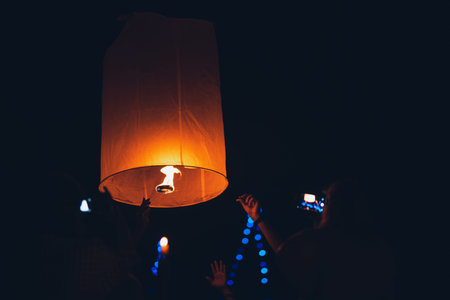 Lighting candles, lanterns in the sky at night in the Lantern Festival