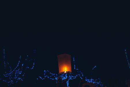 Lighting candles, lanterns in the sky at night in the Lantern Festivalの写真素材