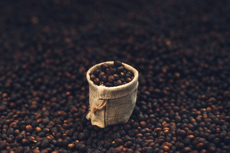 Closeup Dried coffee beans Background-And coffee bean in a small sack