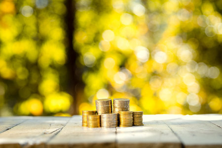 Stacked coins Saving money interest - Orange and green nature background