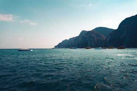 The ocean and the island, the sun and the waves in the evening when sitting on a boat.