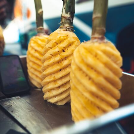 Peeling pineapples-Clear water on the island,Bright blue sea and wooden boatの写真素材